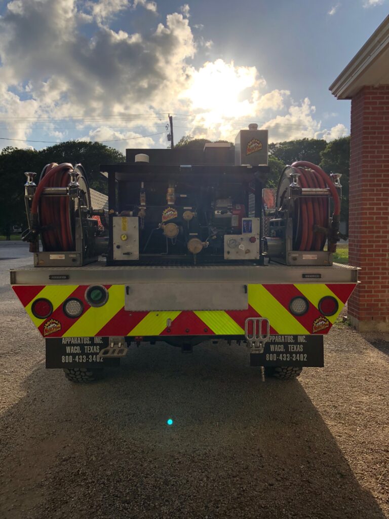 The back of a firetruck that has been equipped with a new donated four hundred gallon water tank