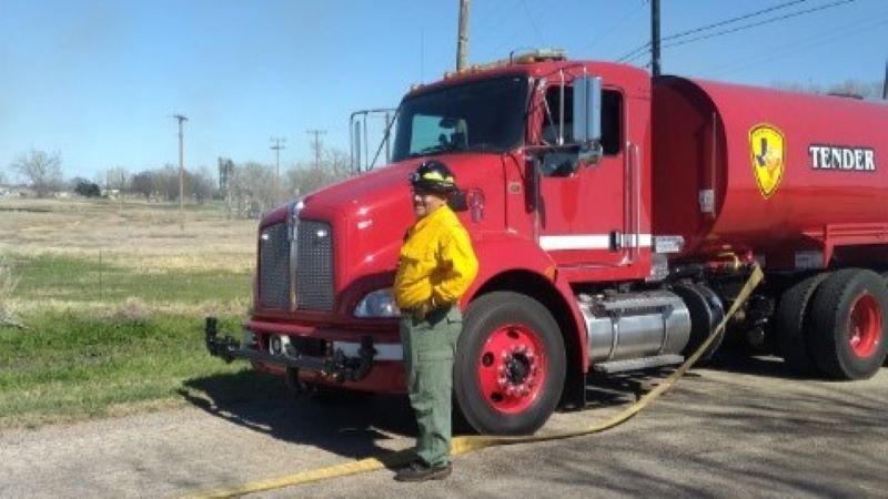 New Friberg-Cooper Fire Truck shown from front side with Friberg-Cooper Fire Chief standing next to it