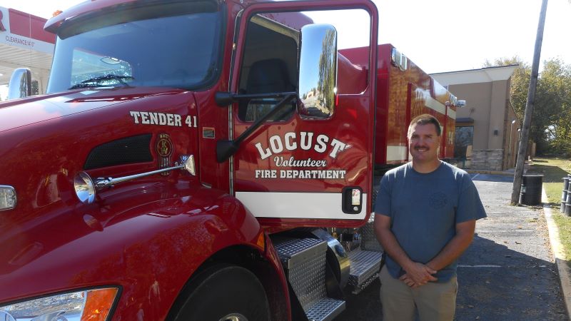 New Locust Fire Truck shown from front with Locust Fire Chief standing next to it.
