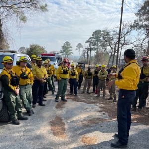 Group of firefighters stand in a circle