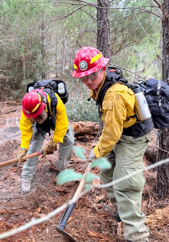 Firefighters using handtools