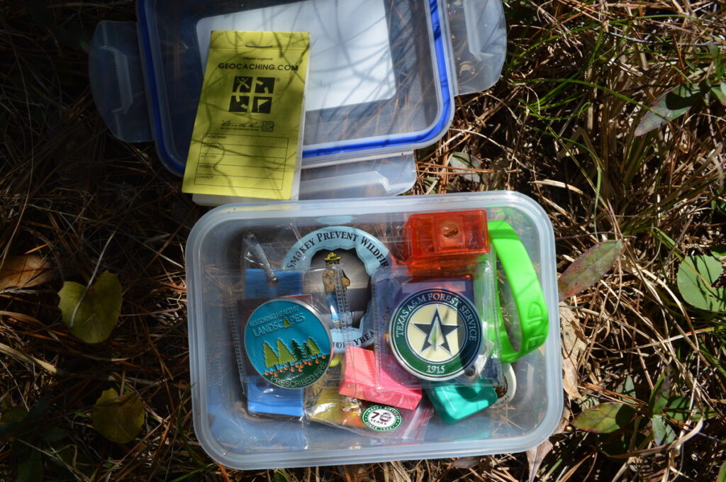 Geocache container with toys and trinkets