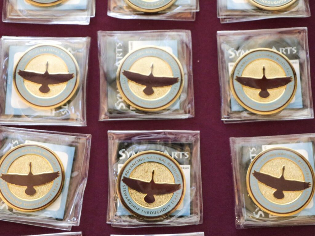 Challenge coins with goose in the middle on table