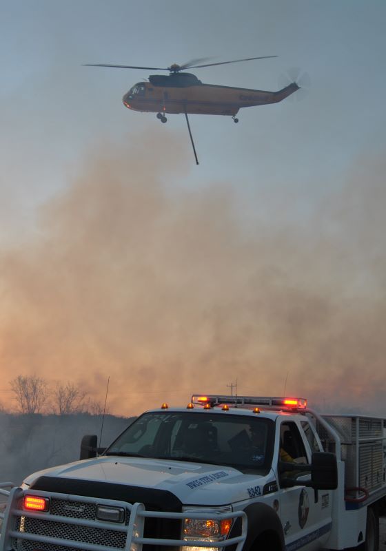 TIFMAS truck with smoke and helecopter above it