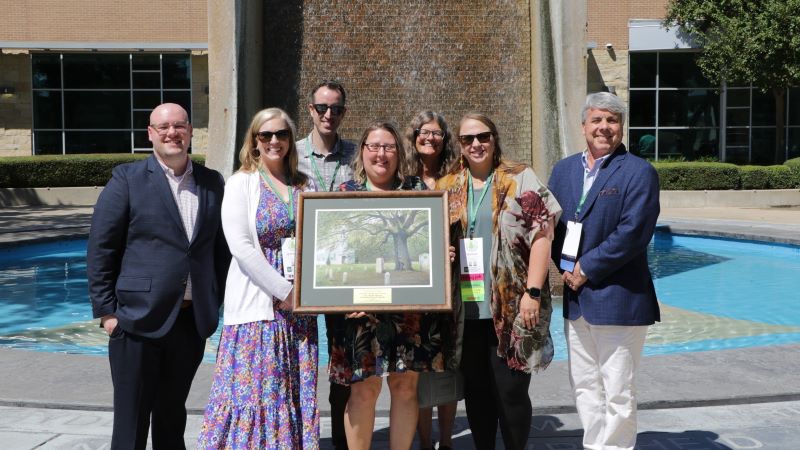 Group of people holding framed award