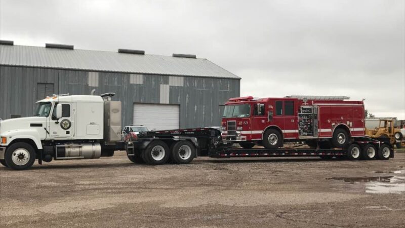 18-wheeler hauling a fire engine