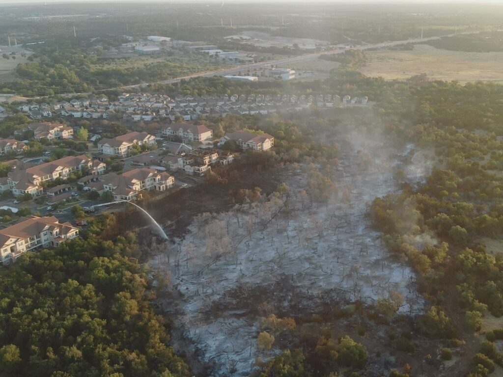 An aerial shot of the burning of parmer lane