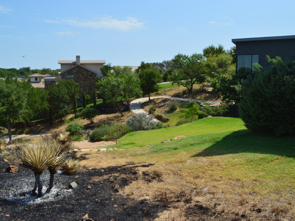 open ground surrounding a house to demonstrate fire resistant landscaping