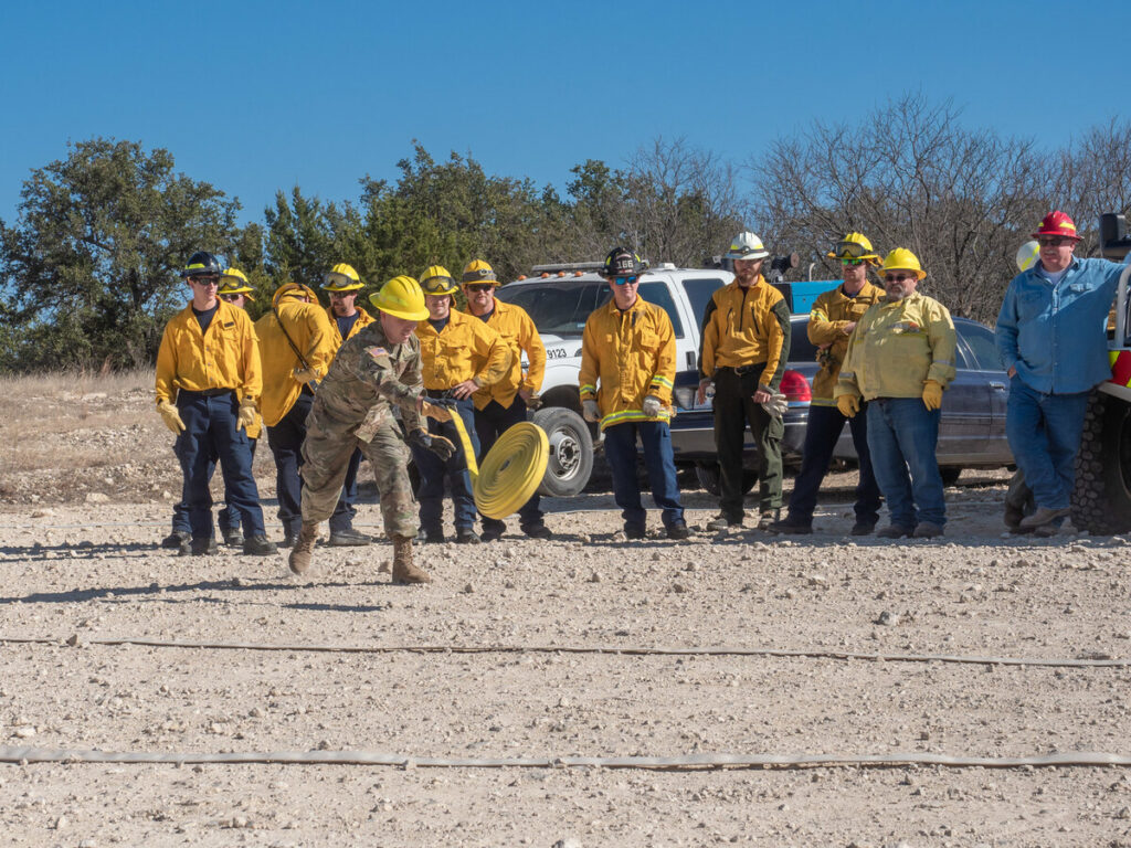 Students in a training session learning how to unravel a firehose