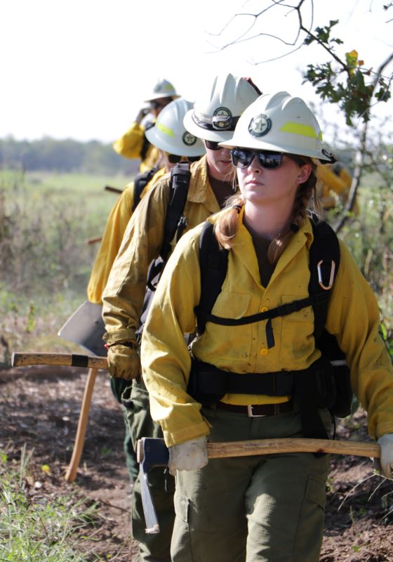 Female firefighter leading hand crew