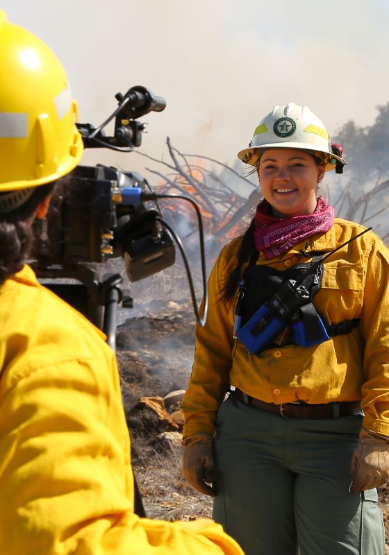 Firefighters smiles at video camera while being interviewed