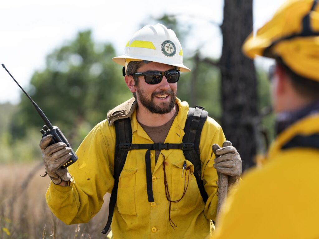 Firefighter holds a walkie talkie