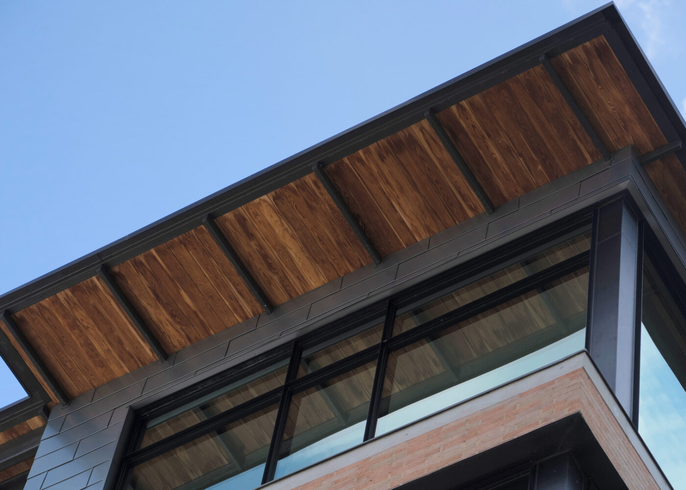 Wood has been utilized to create a decorative underside of a house roof