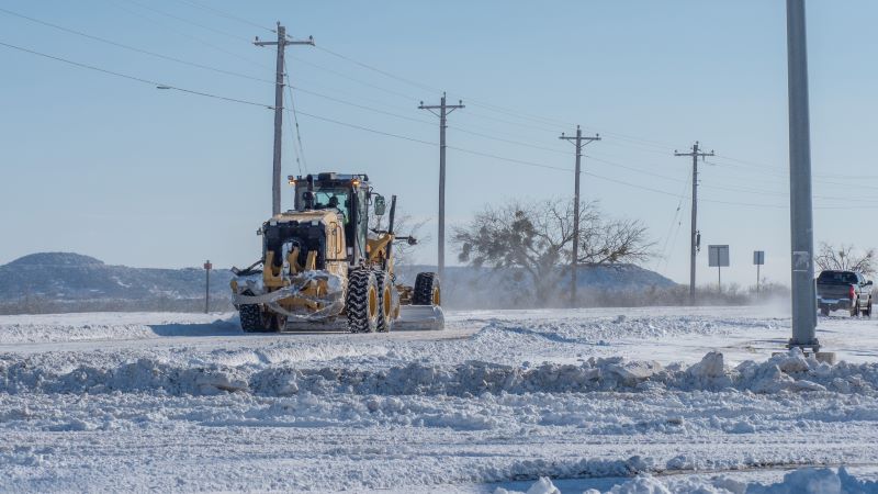 Motorgrader clears roadway of snow