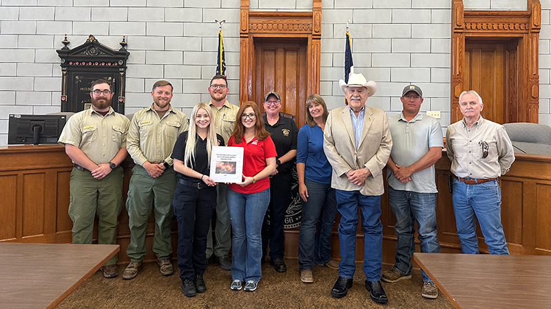 Texas A&M Forest Service members stand with representatives of Hood and Somervell counties.