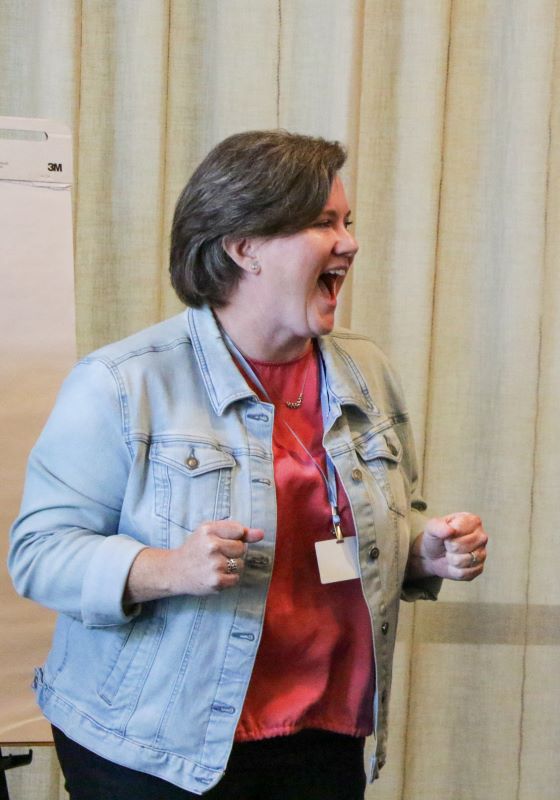 Women looks excitedly to room with name tag on