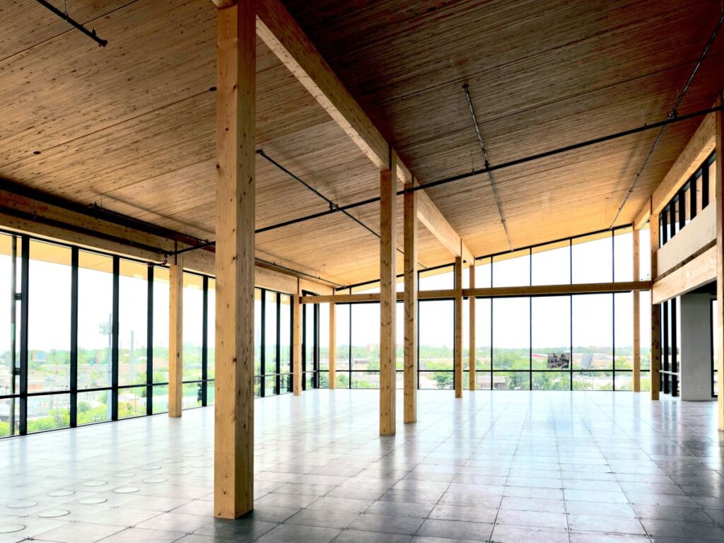Open room with glass windows and wooden beams with wooden ceiling.